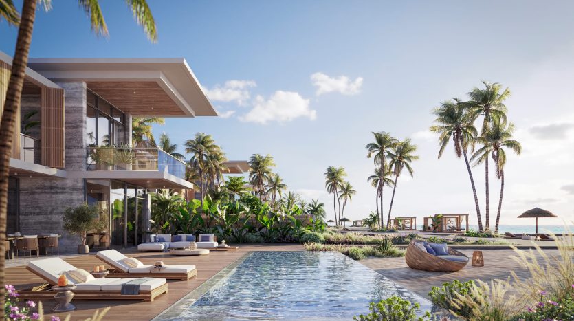 Un luxueux complexe tropical doté d'une grande piscine entourée de palmiers, de chaises longues, d'une végétation luxuriante et de villas modernes en bord de mer avec vue sur l'océan, parfait pour ceux qui s'intéressent à l'immobilier Dubaï.