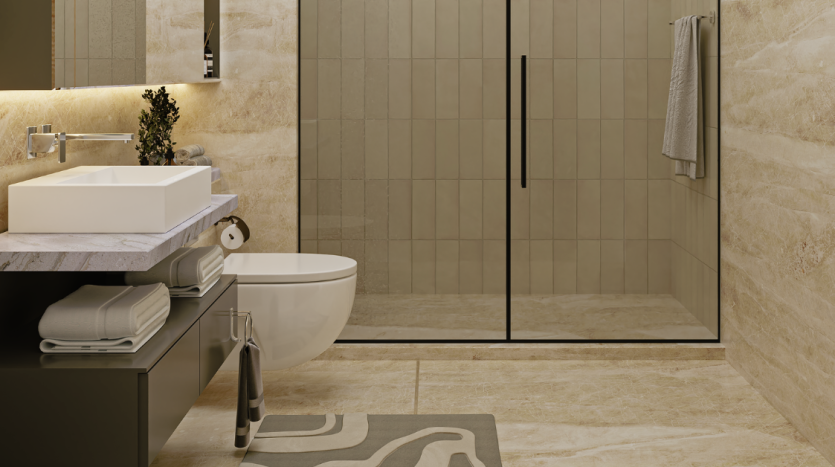 Intérieur de salle de bains moderne comprenant un comptoir en marbre avec un lavabo rectangulaire, un robinet mural, une baignoire autoportante et une cabine de douche en verre contre un mur carrelé dans une villa de Dubaï.