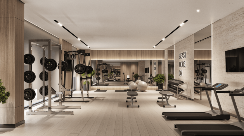 Un intérieur de salle de sport moderne dans un appartement haut de gamme à Dubaï, comprenant de nombreuses stations d&#039;haltérophilie et tapis roulants, un design minimaliste avec des accents en bois, un éclairage lumineux et des panneaux de motivation comme « mode bête activé »