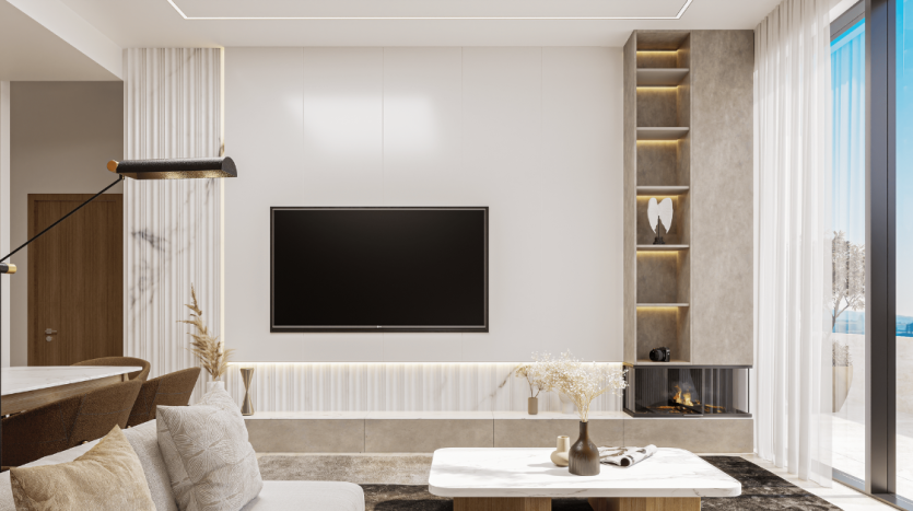 Un salon moderne dans un appartement de Dubaï avec une grande télévision sur un mur blanc, une cheminée, des étagères minimalistes au décor, un canapé et de grandes fenêtres offrant une vue sur la plage.
