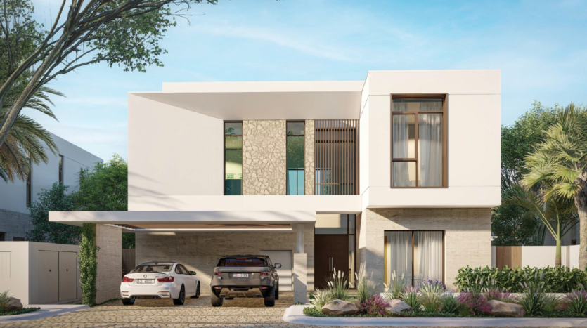 Villa moderne de deux étages à Dubaï avec un toit plat, dotée de grandes fenêtres, d&#039;un balcon et d&#039;un abri pour deux voitures. La façade comprend des accents de pierre, entourée d&#039;un jardin paysager.