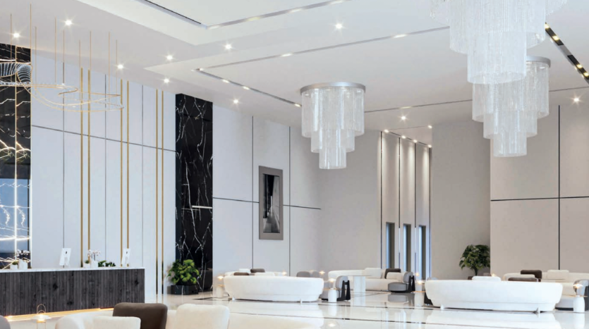 Un hall d'entrée d'hôtel moderne avec d'élégants canapés blancs, des murs en marbre noir avec des accents dorés et d'élégants lustres cylindriques suspendus à un haut plafond éclairé par un éclairage encastré, mettant en valeur le style luxueux typique de