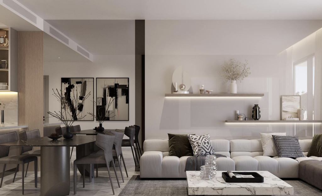 Salon moderne dans un appartement de Dubaï avec canapés beiges, table basse centrale, coin repas attenant avec un set de table gris et décoration minimaliste sous un éclairage tamisé.