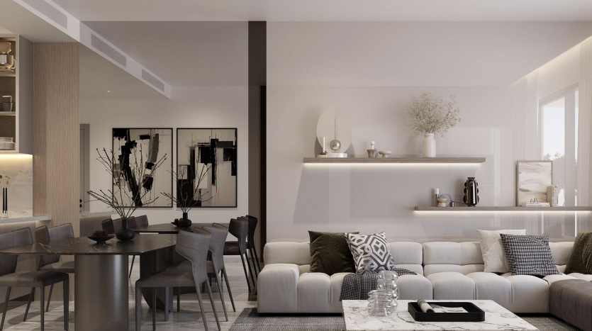 Salon moderne dans un appartement de Dubaï avec canapés beiges, table basse centrale, coin repas attenant avec un set de table gris et décoration minimaliste sous un éclairage tamisé.
