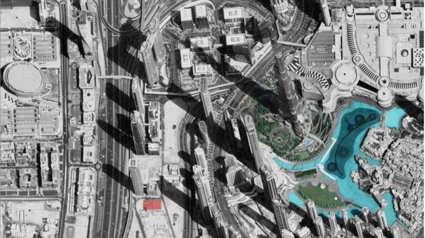 Image aérienne en niveaux de gris d&#039;une ville avec des autoroutes, des échangeurs routiers complexes et des bâtiments urbains environnants. Les caractéristiques notables incluent des plans d&#039;eau d&#039;un bleu éclatant et des accents de verdure à proximité de la luxueuse villa de Dubaï.