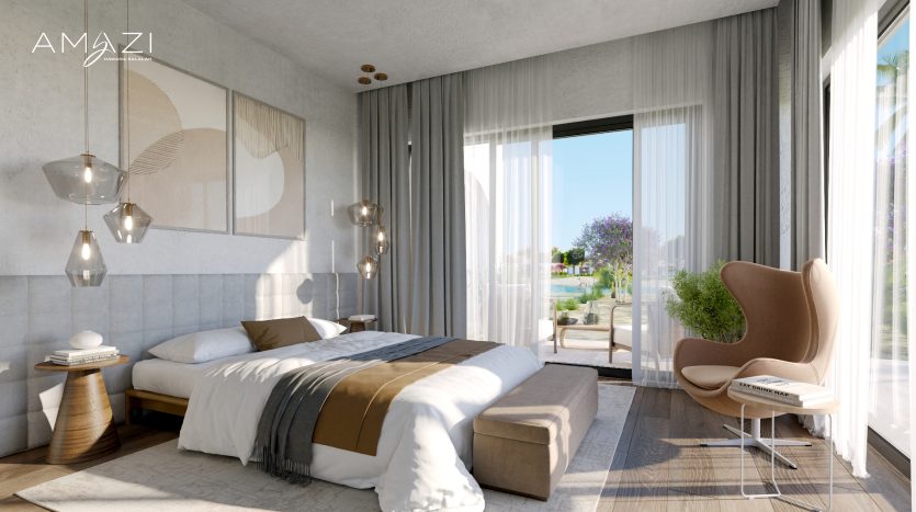 Chambre moderne et lumineuse dans une villa de Dubaï avec de grandes fenêtres donnant sur un jardin extérieur. Elle comprend un lit moelleux, des lampes suspendues et un coin lecture confortable avec un fauteuil. Rideaux texturés et