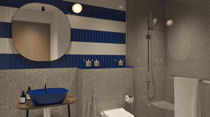 Une salle de bains moderne avec des murs à rayures bleues et blanches, un miroir mural rond, une vasque bleue sur un support en bois, une baignoire blanche et un espace douche ouvert dans une propriété de premier immobilier à Dubaï
