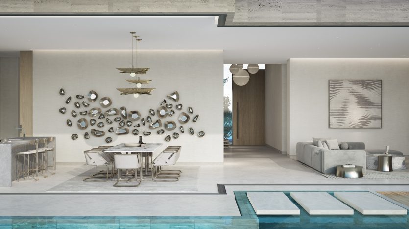 Espace de vie moderne et spacieux au design décloisonné idéal pour l&#039;immobilier Dubaï, comprenant une cuisine avec îlot en marbre, un coin repas avec une table élégante et un salon donnant sur une piscine intérieure.