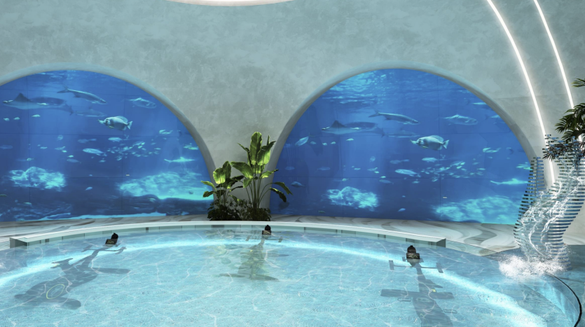 Une piscine intérieure avec des gens profitant de l&#039;eau, entourée de grandes fenêtres avec vue sur l&#039;aquarium montrant diverses créatures marines nageant, sous des arches courbes et modernes et une pièce maîtresse botanique dans une luxueuse villa à Dubaï.