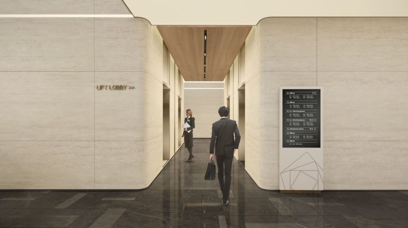 Un homme en costume se dirige vers une femme dans le couloir d’un immeuble de bureaux moderne à Dubaï, en passant devant un panneau d’annuaire. L&#039;intérieur présente des murs en pierre simples et élégants et un éclairage chaleureux.