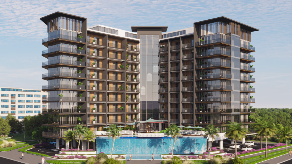 Immeuble résidentiel moderne de plusieurs étages avec de grands balcons en verre, entouré d'une verdure luxuriante et d'un espace piscine en face, avec un ciel bleu clair au-dessus, incarnant la vie en appartement de luxe de style Dubaï.