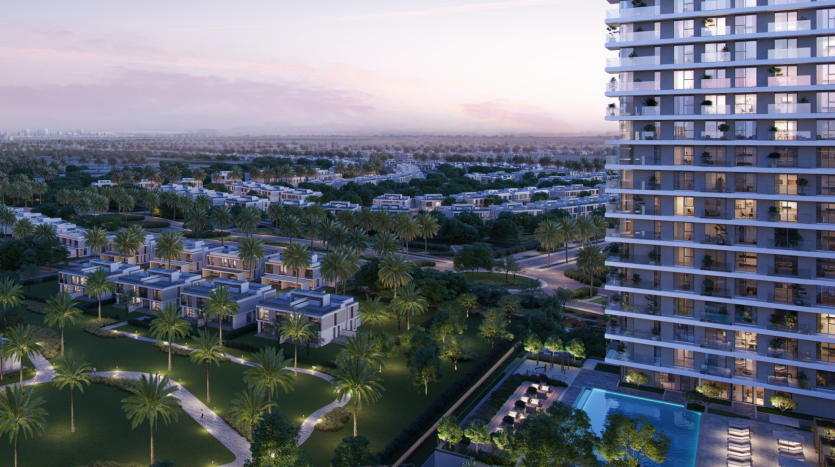 Vue aérienne d&#039;un quartier résidentiel luxueux de Dubaï comprenant des villas modernes entourées d&#039;une verdure luxuriante, avec un immeuble de grande hauteur sur la droite et un horizon de la ville visible au loin au crépuscule.