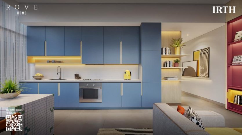 Intérieur de cuisine moderne avec armoires bleues, appareils intégrés et bouilloire aux accents jaunes. Coin salon avec un canapé gris et des étagères rouges visibles dans l&#039;aménagement ouvert de la villa Dubaï.