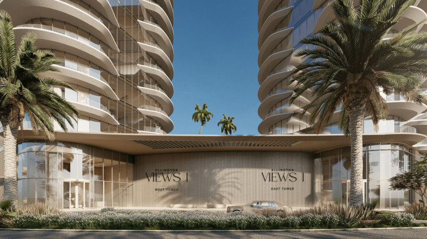 Architecture urbaine moderne composée de deux immeubles de grande hauteur flanqués de palmiers, centrés autour d&#039;une entrée intitulée « Ellington Views | East Tower » dans l&#039;immobilier Dubaï. Une journée ensoleillée améliore le cadre serein.