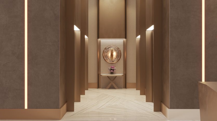 Un couloir moderne dans un appartement de Dubaï comprenant de hautes colonnes élancées avec un éclairage d&#039;ambiance rose, un miroir décoratif bordé d&#039;or monté sur un mur texturé à l&#039;extrémité, au-dessus d&#039;une petite table avec un