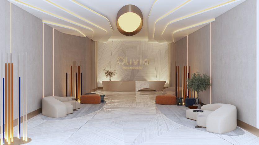 Un hall d&#039;entrée moderne et élégant avec des sièges moelleux, un éclairage d&#039;ambiance aux motifs géométriques et un mur central portant le nom « Olivia Residences » en lettres dorées – un investissement idéal à Dubaï