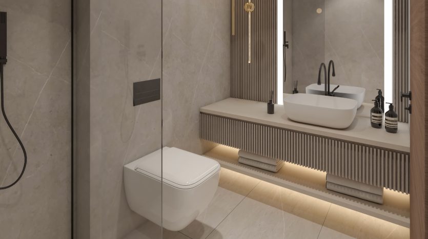 Salle de bain moderne dans une villa de Dubaï comprenant des toilettes murales, une double vasque avec vasques, de grands miroirs et un éclairage d&#039;ambiance sous les armoires. Les tons neutres et les lignes épurées créent un look contemporain.