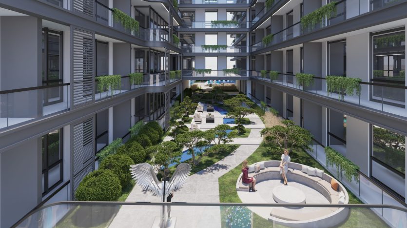 Une cour spacieuse et moderne d&#039;un complexe d&#039;appartements à Dubaï comprenant des jardins paysagers, des sentiers pédestres et des coins salons, où les résidents profitent du plein air, entourés de bâtiments à plusieurs étages ornés de balcons verts.