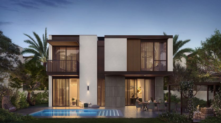 Une maison moderne de deux étages à Dubaï éclairée au crépuscule, dotée d&#039;un balcon, de grandes fenêtres, d&#039;une piscine entourée de palmiers luxuriants et d&#039;un patio confortable.