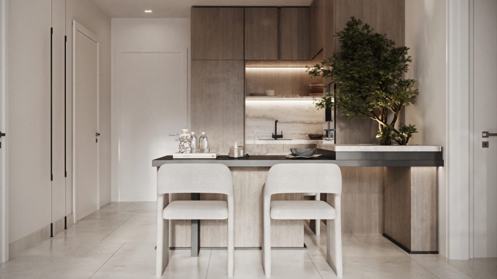 Intérieur de cuisine moderne dans une villa de Dubaï avec des armoires en bois élégantes, un dosseret en marbre et un îlot central avec deux tabourets de bar. Une plante décorative ajoute une touche de verdure.