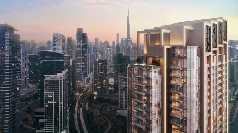 Une vue sur le paysage urbain au coucher du soleil avec des gratte-ciel modernes avec un bâtiment important éclairé par un éclairage doré au premier plan, positionné comme une opportunité d&#039;investissement idéale à Dubaï. Le ciel est peint dans des tons de rose et de bleu