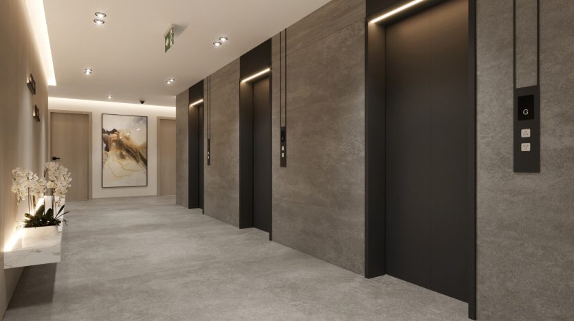 Un hall d&#039;ascenseur moderne et élégant avec deux ascenseurs fermés, des panneaux gris et noirs, un éclairage élégant et une peinture décorative au bout du couloir, parfait pour un investissement à Dubaï