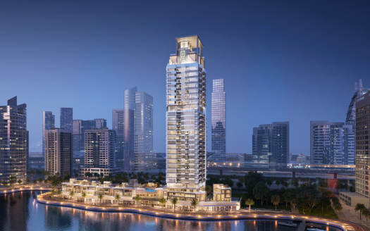 Un gratte-ciel moderne avec des balcons uniques éclairés au crépuscule, entouré d&#039;autres immeubles de grande hauteur le long d&#039;un front de mer incurvé dans un cadre urbain à Dubaï.