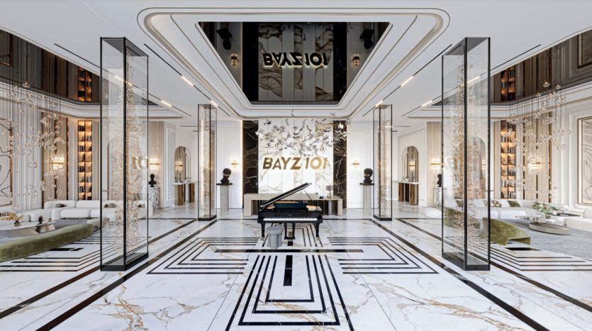 Luxurious lobby with geometrically patterned marble floors, elegant white and gold décor, mirrored columns and grand piano in the center. The name "BAYZION" stands out as one of Dubai's first elite real estate properties.