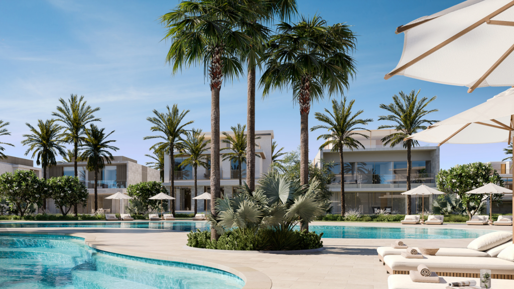 Une piscine luxueuse entourée de palmiers, de cabanes et de chaises longues sous un ciel bleu clair. L'architecture moderne des villas blanches complète l'aménagement paysager tropical.