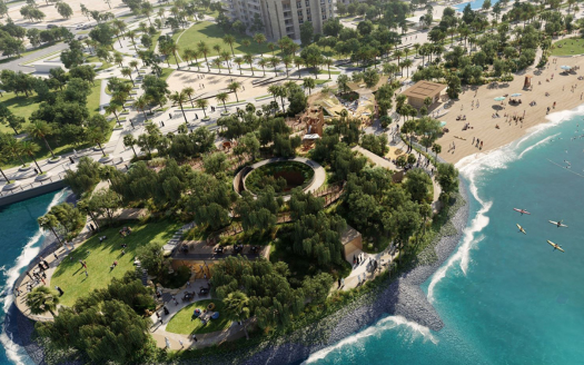 Vue aérienne d'un parc verdoyant sur une péninsule, entouré d'une plage de sable fin et d'eaux bleues claires, avec un paysage urbain et des rues qui le flanquent, représentant parfaitement le style de vie luxueux recherché dans l'immobilier Dubaï.