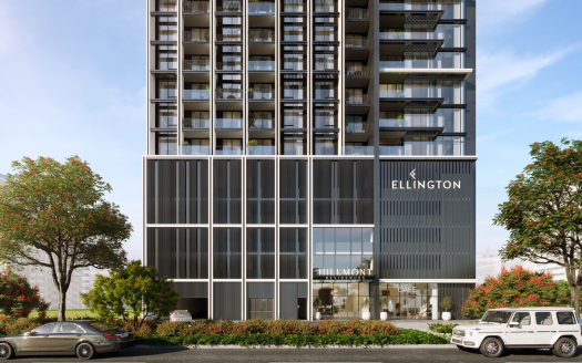Immeuble moderne de grande hauteur avec une façade élégante en verre et en métal arborant le logo Ellington, aménagé avec des arbustes et des arbres aux couleurs vives, flanqué de voitures de luxe dans l&#039;immobilier de Dubaï.