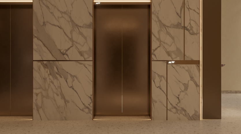 La section murale revêtue de marbre des Primero Residences Al Furjan présente un design minimaliste, avec deux portes d&#039;ascenseur avec un éclairage subtil. Les ascenseurs sont encadrés dans une finition dorée, rehaussant l’aspect luxueux de la surface en marbre.