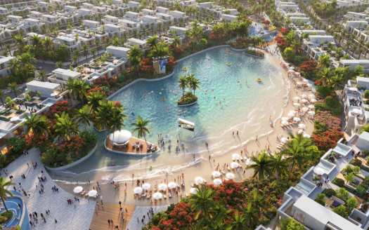 Vue aérienne d'un complexe luxueux doté d'une grande piscine de style lagon entourée d'une végétation tropicale luxuriante et de nombreuses villas blanches sous un ciel ensoleillé dans le sud de Dubaï.