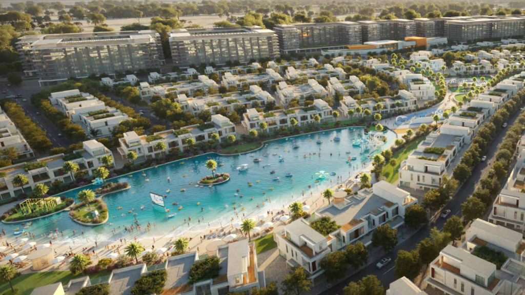 Vue aérienne d&#039;un quartier résidentiel moderne du sud de Dubaï comprenant un grand lac artificiel central, entouré de bâtiments blancs et d&#039;une verdure luxuriante, avec des gens pratiquant diverses activités nautiques.
