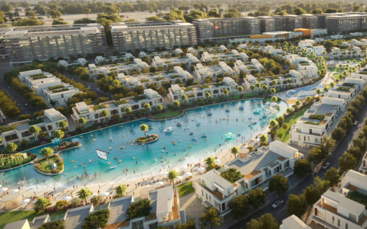 Vue aérienne d'un quartier résidentiel moderne du sud de Dubaï comprenant un grand lac artificiel central, entouré de bâtiments blancs et d'une verdure luxuriante, avec des gens pratiquant diverses activités nautiques.