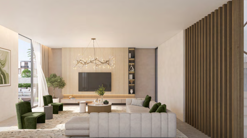 Un salon spacieux dans une villa de Dubaï comprenant un grand canapé beige, deux fauteuils verts et une unité murale centrale en bois avec télévision montée. La pièce est accentuée par un style de branche décoratif