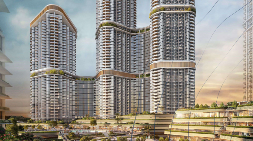 Un complexe architectural moderne sur l'avenue Sobha se compose de trois grands gratte-ciel interconnectés avec des éléments de conception incurvés. Les bâtiments présentent de nombreux balcons, de la verdure et une façade dynamique. La base comprend des espaces commerciaux et des espaces paysagers. Le ciel est partiellement nuageux.