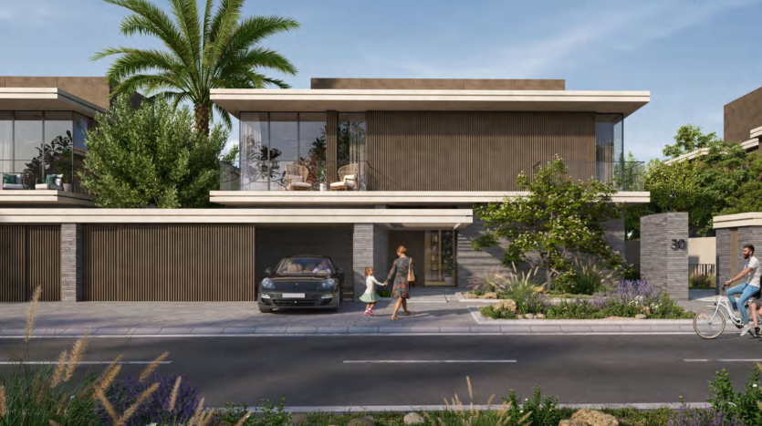 Une scène de rue résidentielle moderne à Dubaï montrant une villa contemporaine avec de grandes fenêtres et un toit plat, entourée d'une verdure luxuriante. Une femme passe devant la maison tandis qu’une autre personne passe devant elle à vélo.