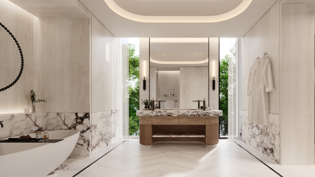 Une luxueuse salle de bains moderne de la Villa Karl Lagerfeld avec des murs et un comptoir en marbre, une vanité en bois, un grand miroir et un éclairage d'ambiance zénithal. Une baignoire et de la verdure sont visibles sur le côté.