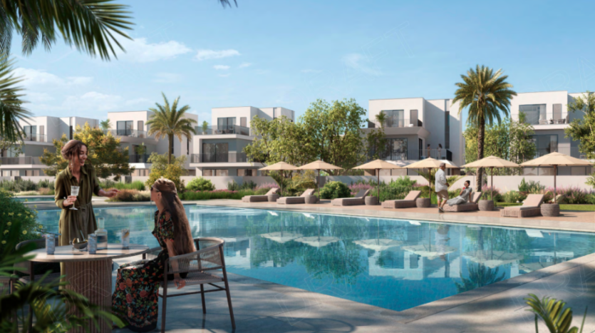 Complexe résidentiel moderne sur Golf Lane, composé de bâtiments blancs au sommet plat et de balcons entourant une grande piscine rectangulaire. Deux femmes discutent autour d’une table au bord de la piscine, tandis que d’autres se détendent sur des chaises longues sous des parasols. Des palmiers et des arbustes luxuriants rehaussent le cadre serein et ensoleillé.