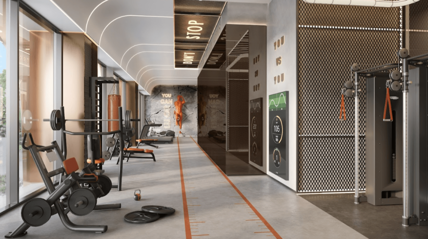 One Residences dispose d'une salle de sport moderne avec des équipements d'exercice comprenant des appareils de musculation, des tapis roulants et des kettlebells. Des phrases de motivation ornent les murs tandis que de grandes fenêtres laissent entrer la lumière naturelle. La salle de sport présente des accents orange et un design élégant et contemporain pour inspirer vos entraînements.