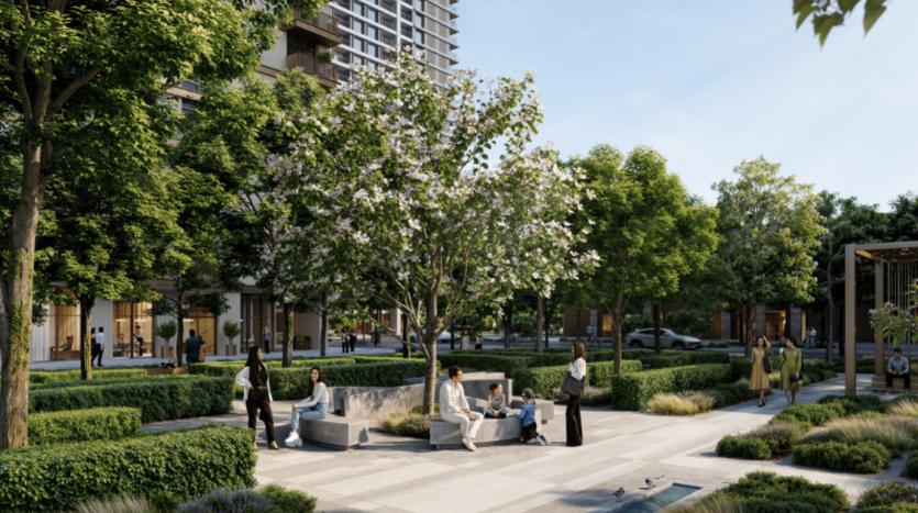 Un parc communautaire avec une végétation luxuriante, des arbres et diverses plantes. Les gens sont assis sur des bancs, marchent et interagissent. Un grand bâtiment appartenant à Address Residences est visible en arrière-plan. L'atmosphère semble calme et accueillante.