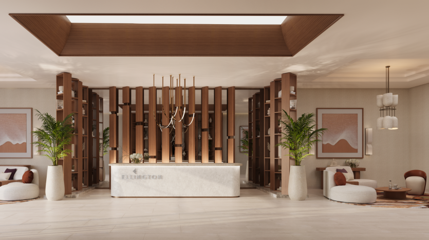 A modern hotel lobby with a reception counter inscribed with "Elmington". Surrounded by tall wooden panels and large potted plants, the space includes contemporary lounge areas with round tables, minimalist chandeliers and abstract artwork, a distinctive feature of Belgrove Residences.