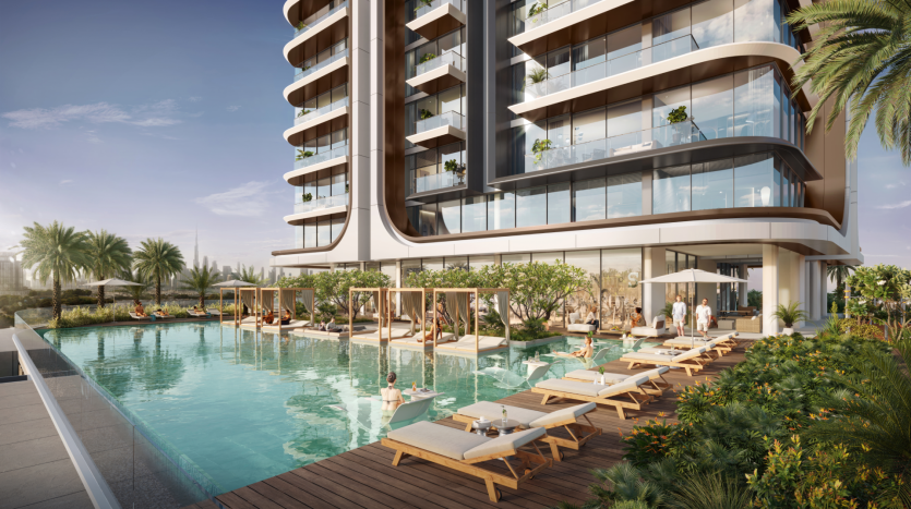 At Belgrove Residences, a luxurious outdoor pool with sun loungers and cabanas offers a serene escape in a modern high-rise building. Guests relax poolside, surrounded by lush greenery and palm trees. The building boasts large bay windows and balconies adorned with plants under clear, sunny skies.