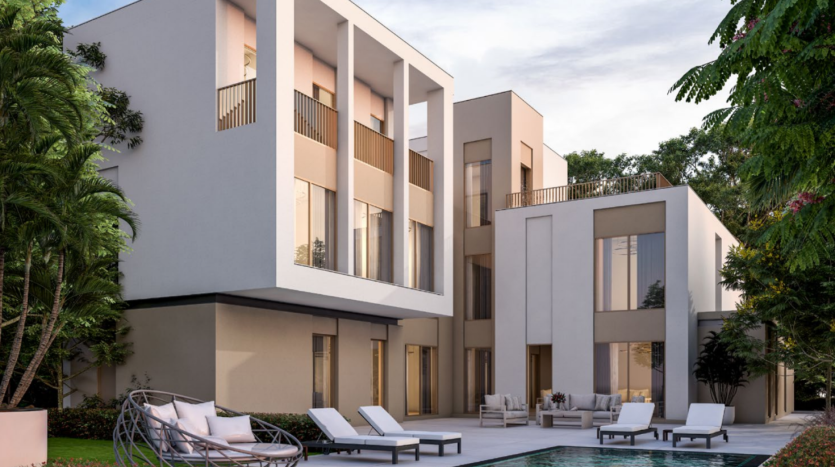 Une villa moderne de deux étages à Sobha Elwood avec de grandes fenêtres et balcons, dotée d'une piscine privée entourée de chaises longues. La villa est située au milieu d'une verdure luxuriante, avec un design épuré et minimaliste et des coins salons extérieurs confortables.