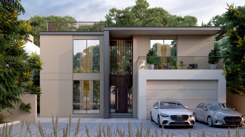 Une maison beige moderne de deux étages à Sobha Elwood dispose de hautes fenêtres et d'un toit plat. Le balcon, perché au-dessus du garage, offre des sièges extérieurs. Devant, une berline noire et une berline argentée sont garées côte à côte. La maison est élégamment encadrée d'arbres et de verdure.