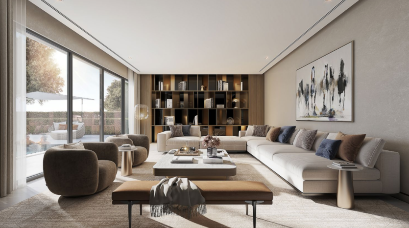 Un salon moderne à Sobha Elwood comprenant un grand canapé sectionnel blanc, des fauteuils marron et un banc beige avec une couverture. L'espace dispose de baies vitrées d'un côté et d'une bibliothèque de l'autre mur, ornées d'art abstrait et d'une palette de couleurs neutres.