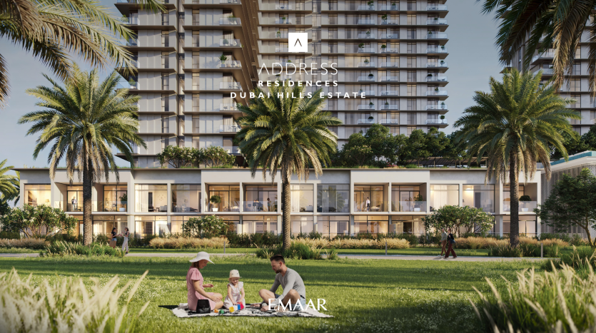 A modern residential building with lush vegetation and palm trees in front. A family of two adults and a child picnic on the lawn. The text "Address Residences Dubai Hills" is displayed at the top.