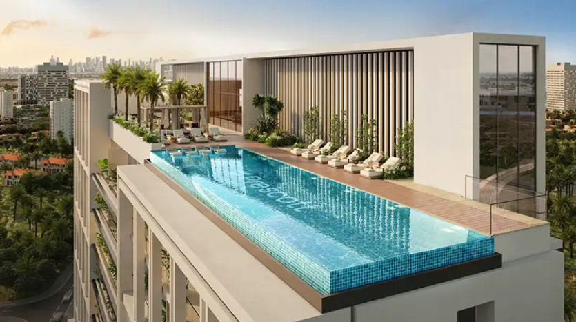 A rooftop infinity pool with sun loungers, palm trees and an urban panorama in the background. The word "Prescott" is visible at the bottom of the pool. The surrounding architecture is modern with large windows and touches of wood, all part of Legado's luxurious design.