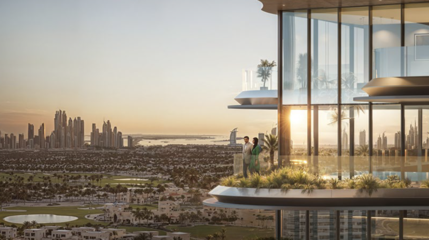 A modern balcony high above the sunset with two people standing by the railing. The view from One Sky Park overlooks a lush cityscape with verdant golf courses, numerous buildings and a distant skyline with iconic skyscrapers and a body of water.